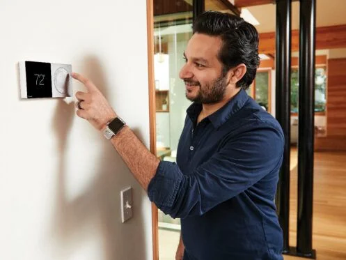 a man checking the thermostat